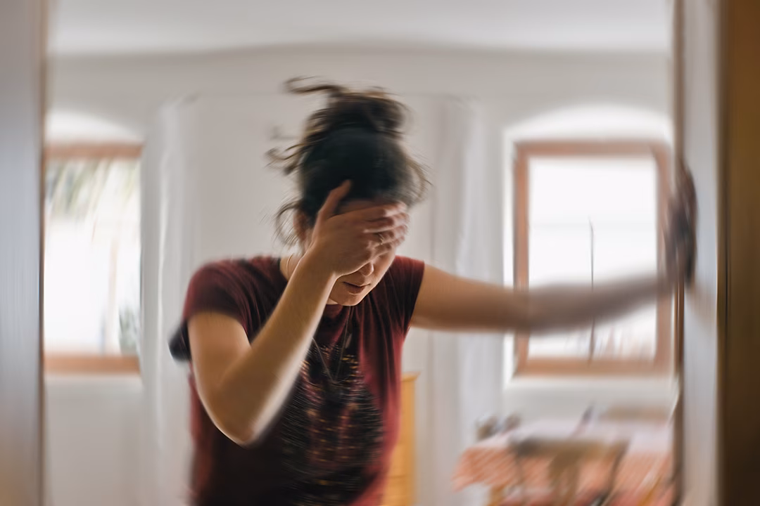 a girl holding her brain in pain