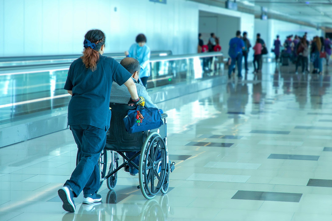 A nurse helping a patient on a wheelchair