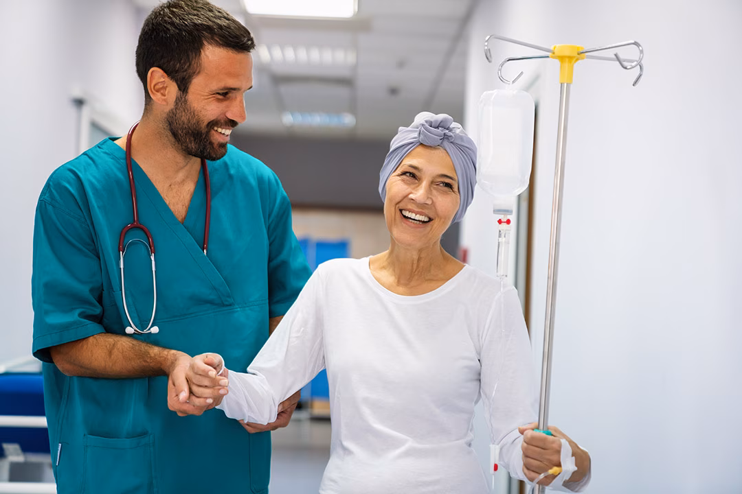 A cancer patient being assisted by a healthcare professional.