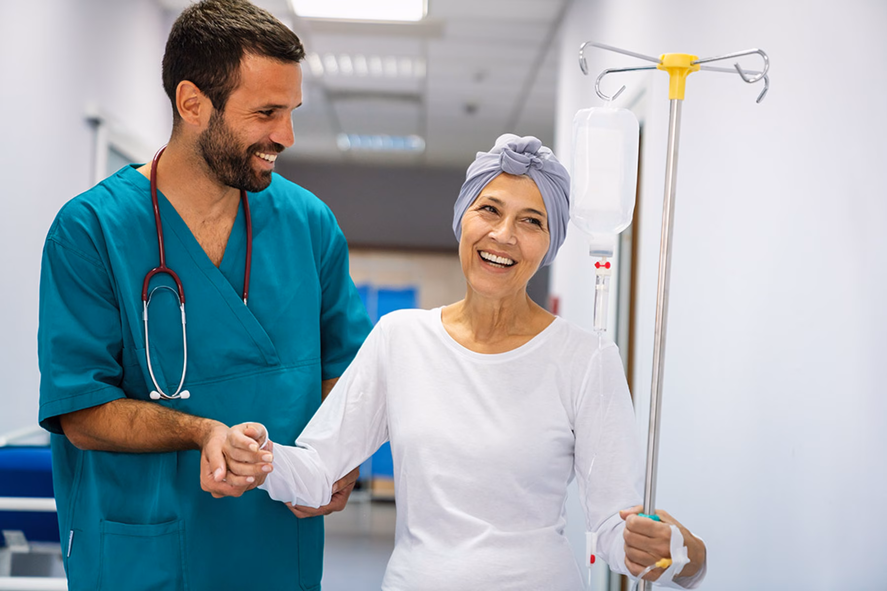 A cancer patient being assisted by a healthcare professional.