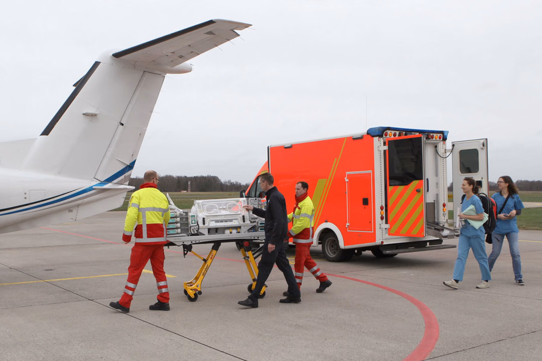 A patient being transported in an incubator