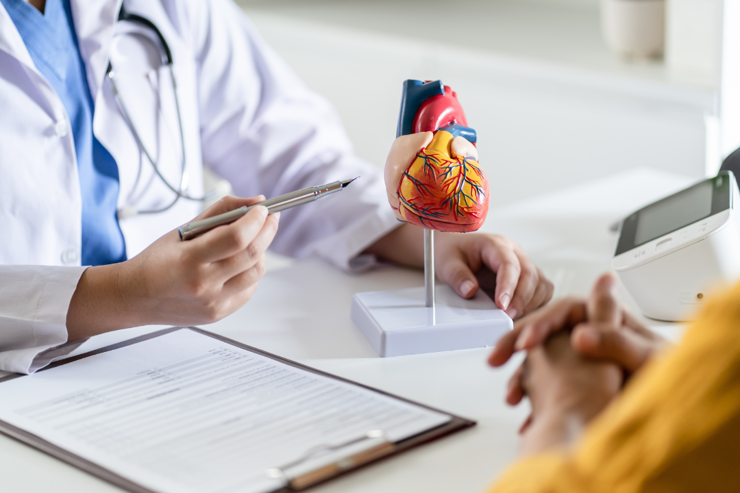 A cardiologist with a heart patient