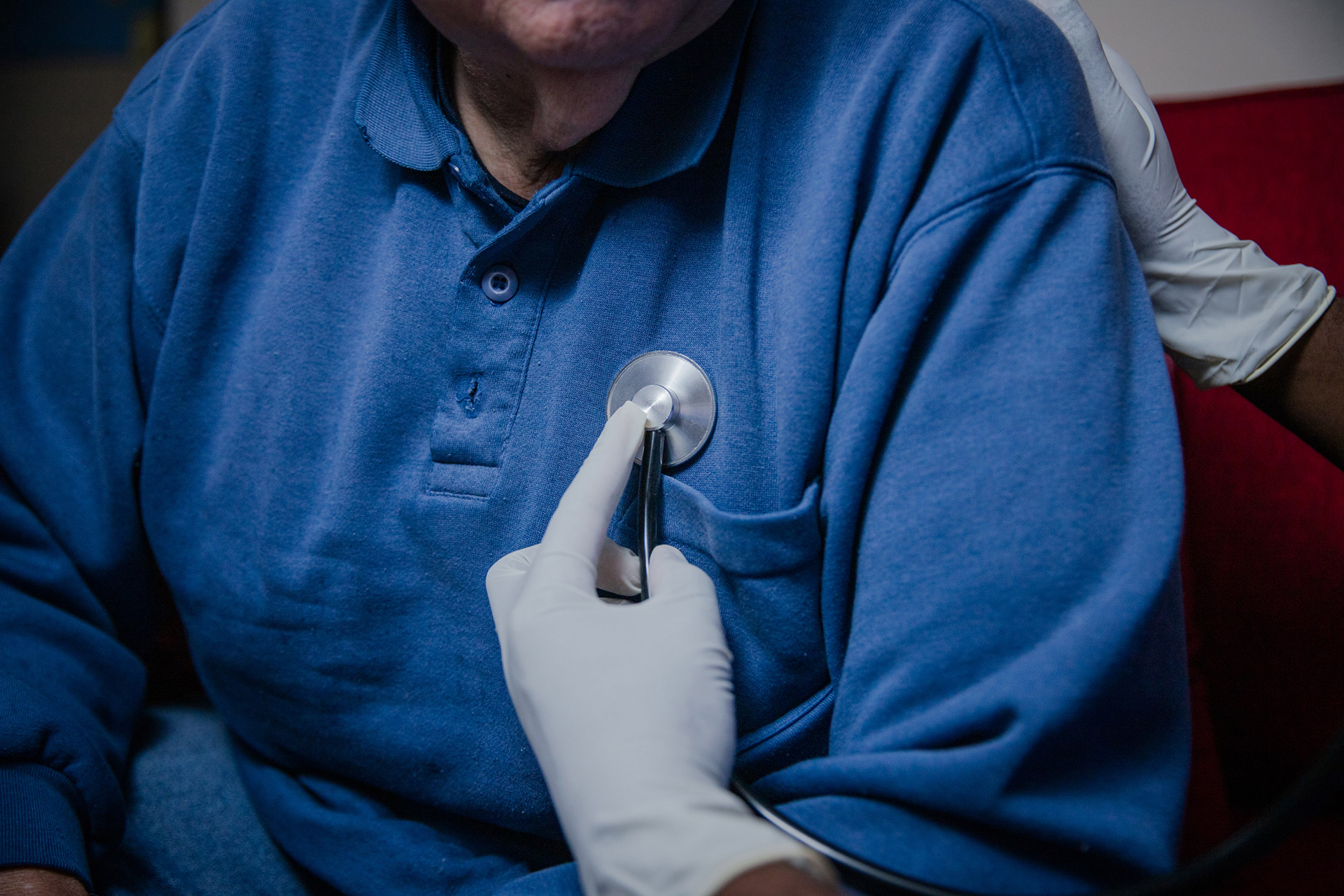 Doctor checking patient's heart