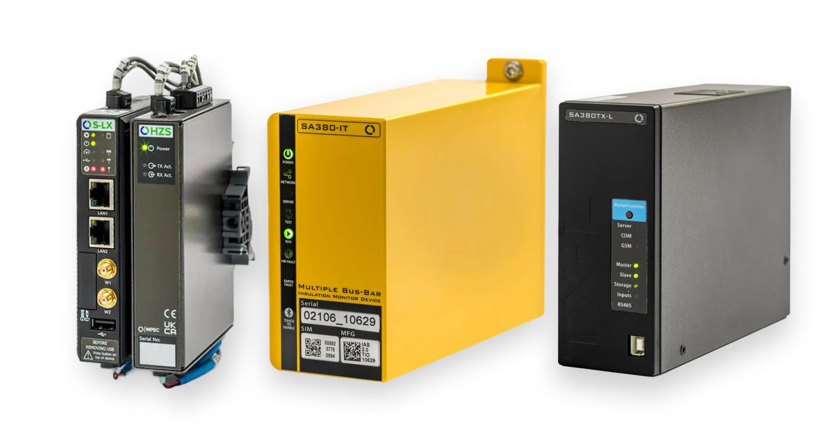 Three rail monitoring devices: a small black unit with ports, a yellow unit, and a larger black unit, each with indicator lights.