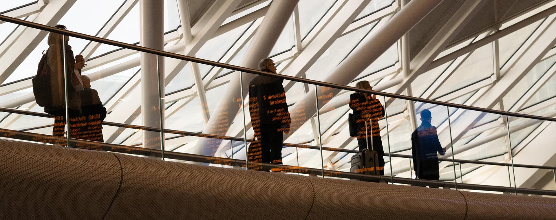 Workers walking across a walkway.