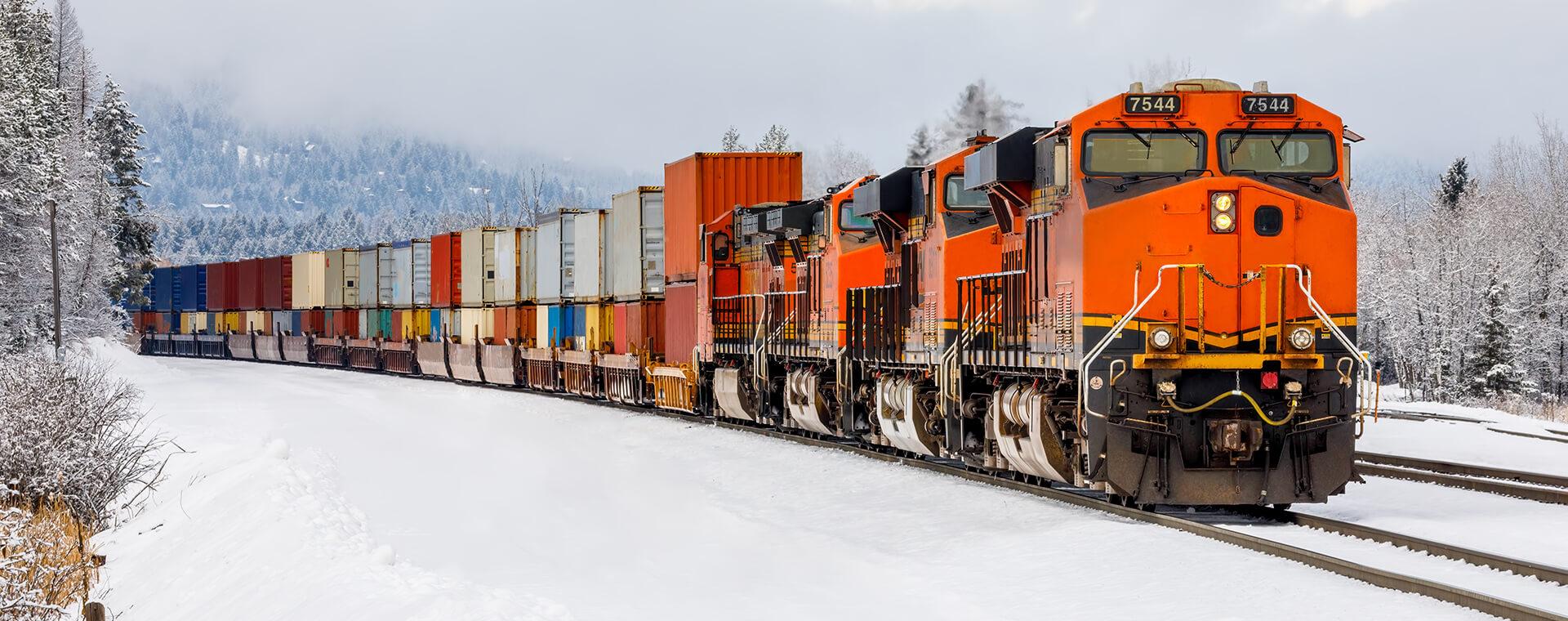 Orange train in the snow.
