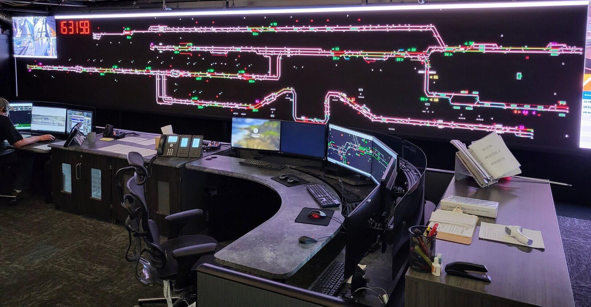 A control room with lots of computer screens.