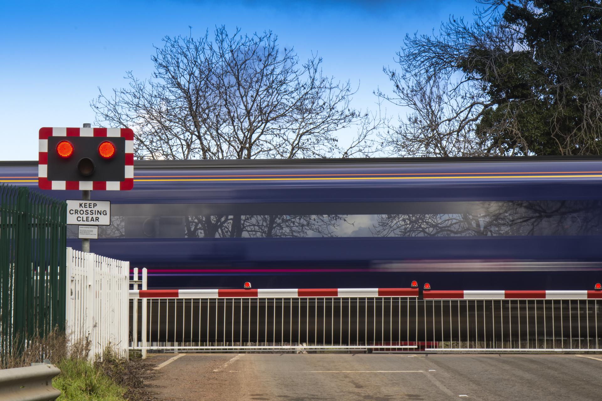 Level crossing with a train passing.
