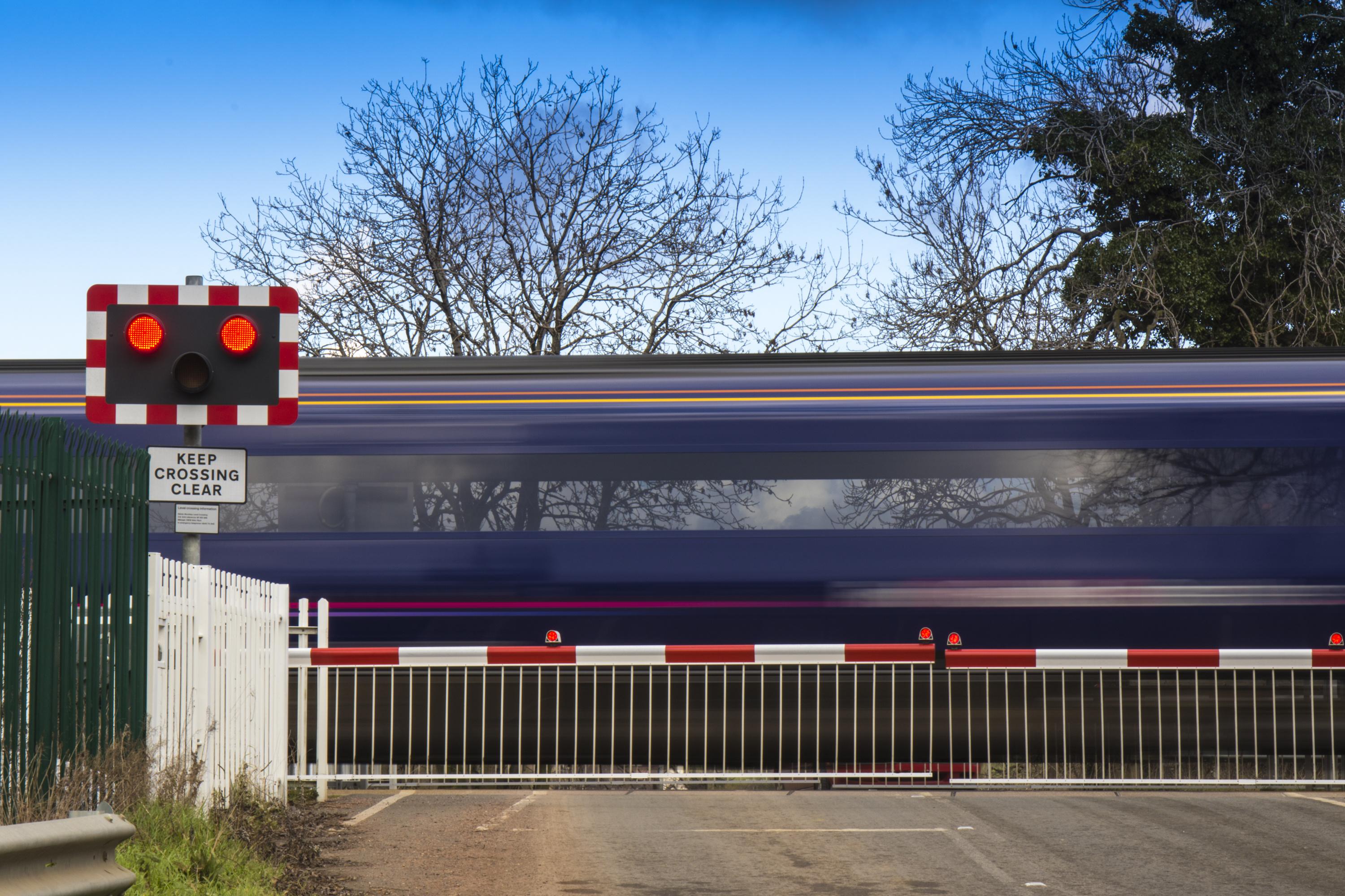 Level crossing with a train passing.