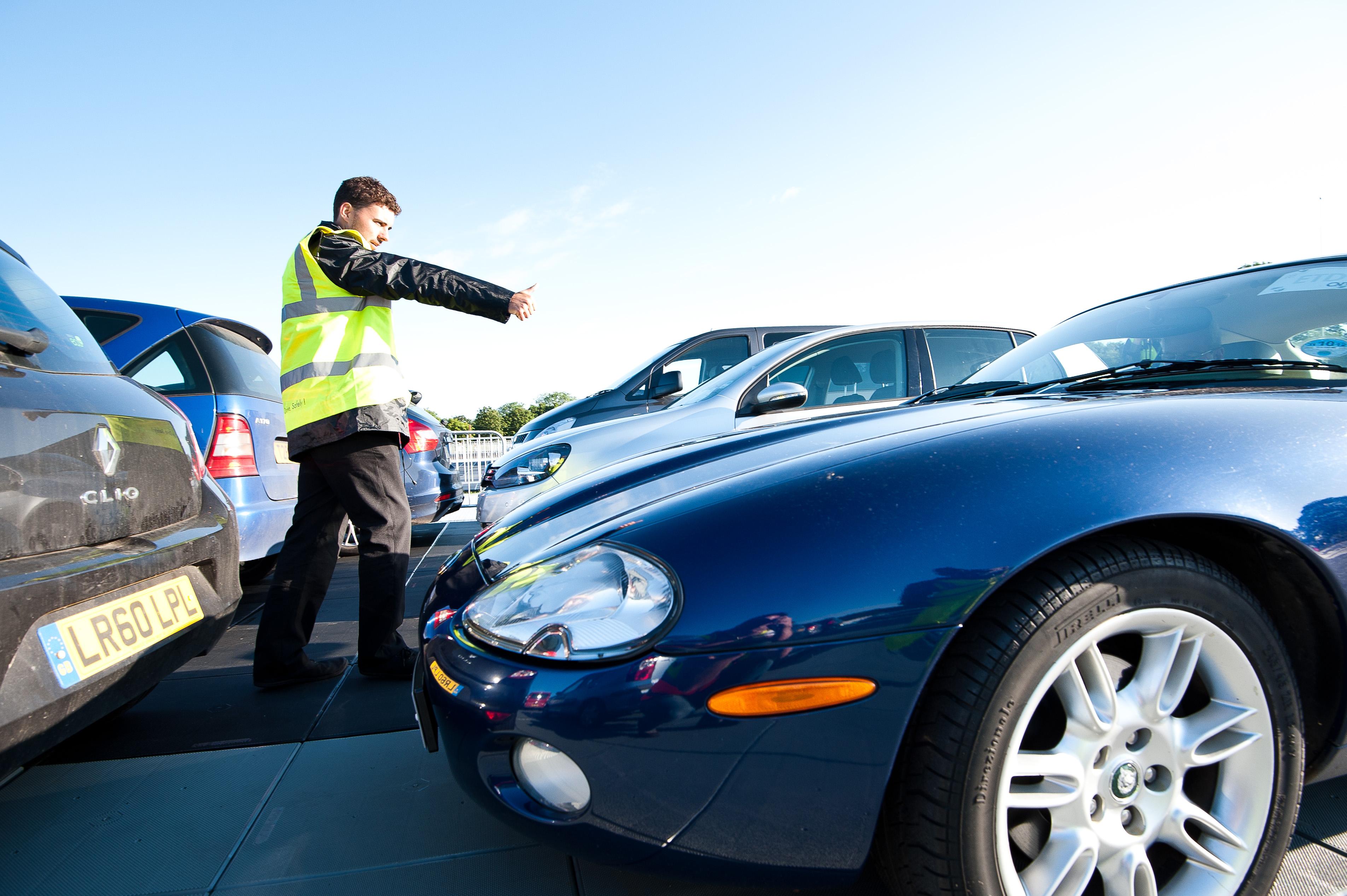 A person in a high visibility jacket directing traffic