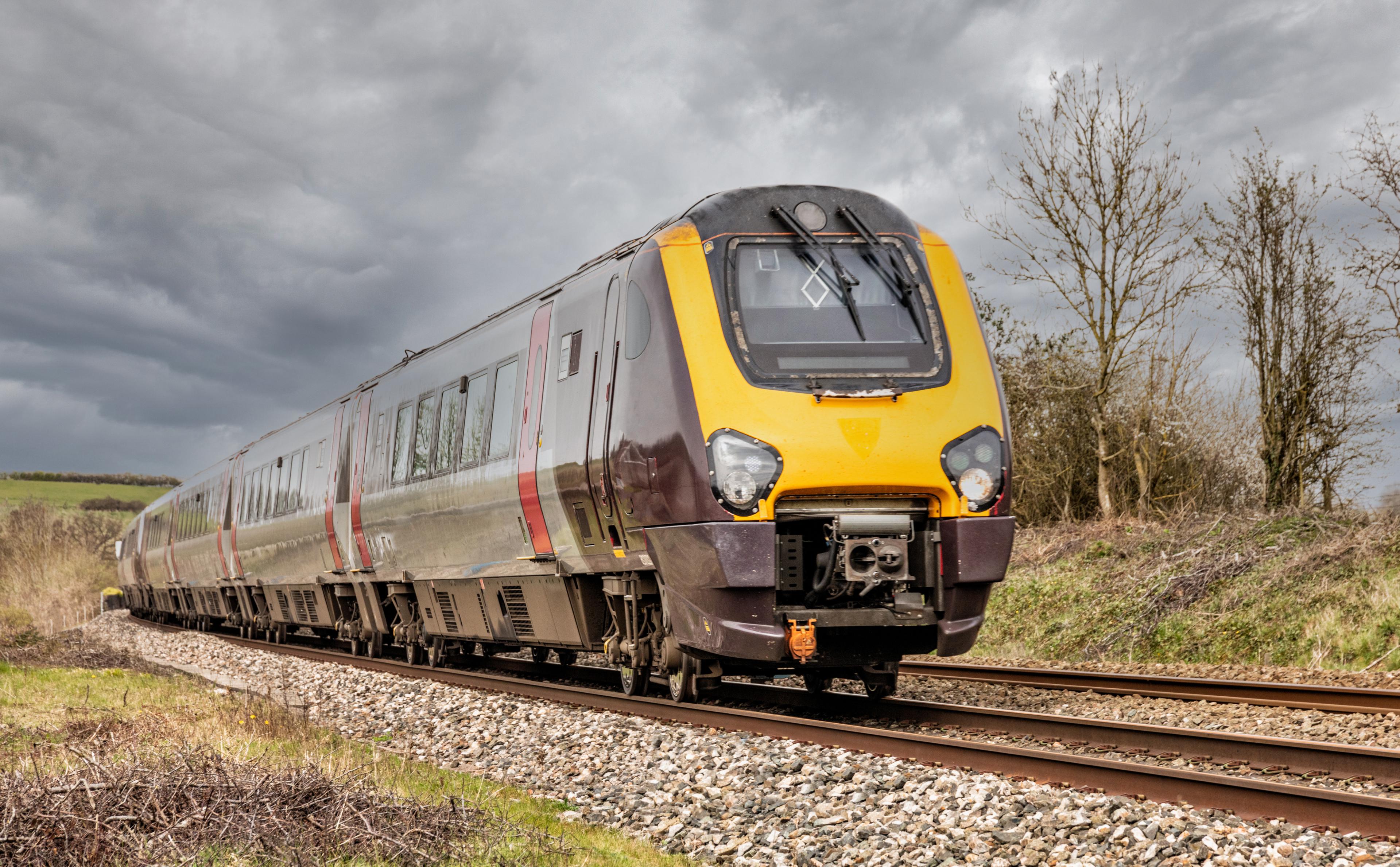 A train passing through the country on a rail track.