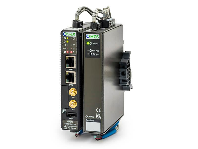 A black industrial network device with multiple ports and indicator lights, including LAN and Wi-Fi connections, mounted on a DIN rail.