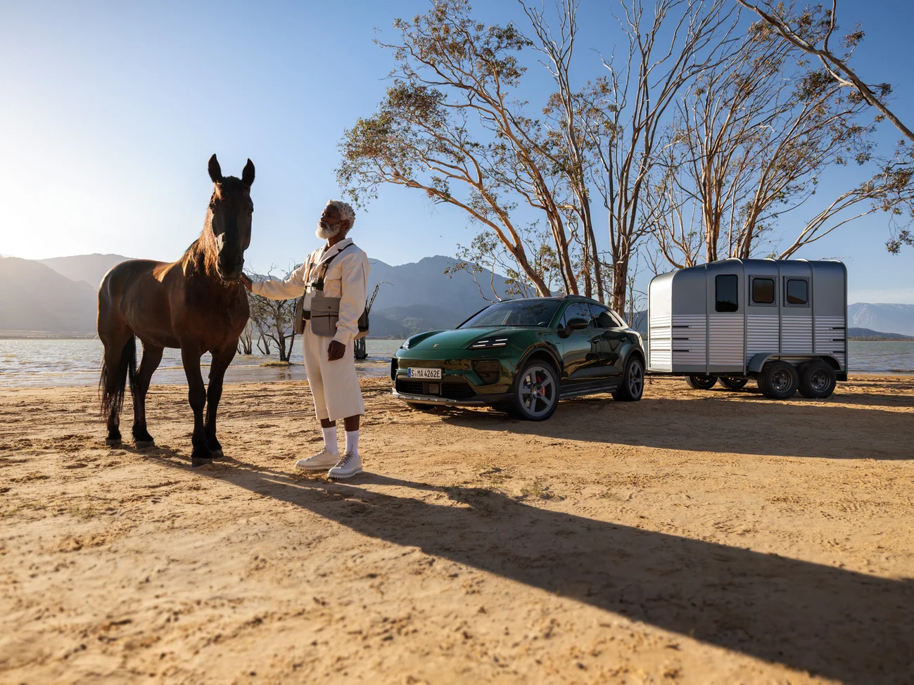 Several dynamic shots of an Oak Green Metallic Neo Macan 4S driving through the desert.
