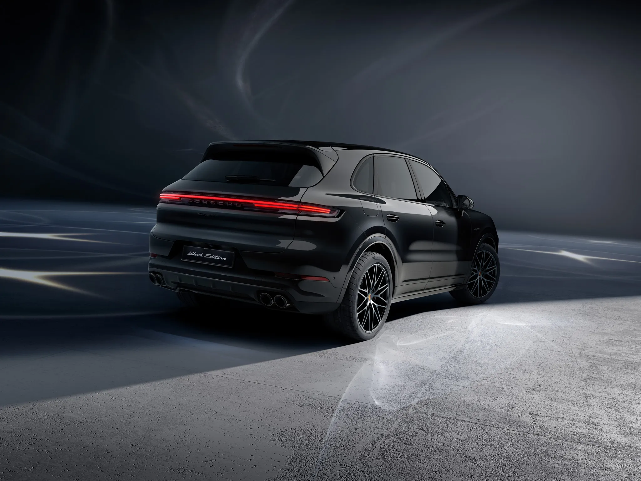 Shot of the back of a Cayenne E-Hybrid Black Edition in a dark location