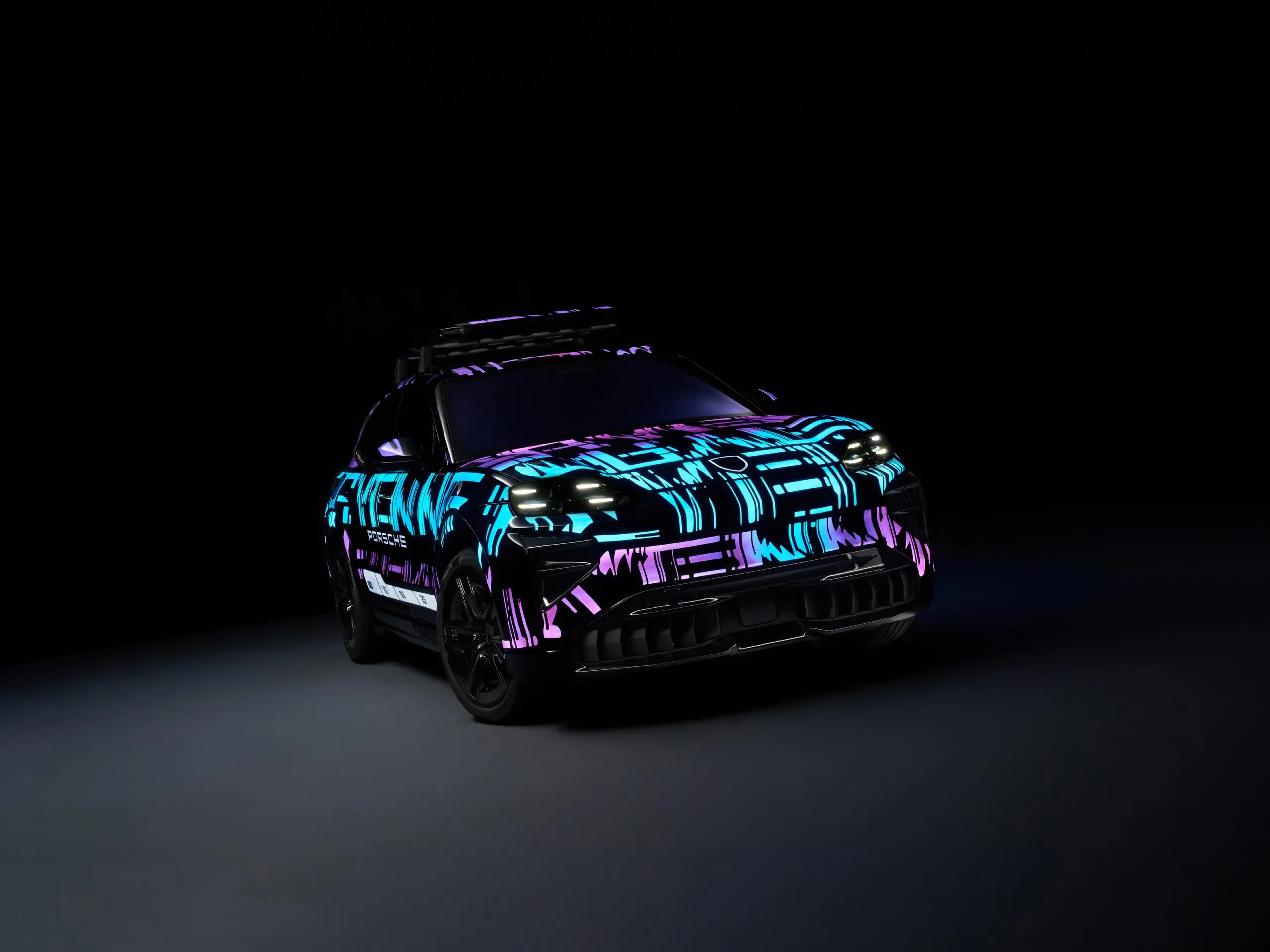Side shot of a Cayenne Electric with blue and purple lights in a dark location.