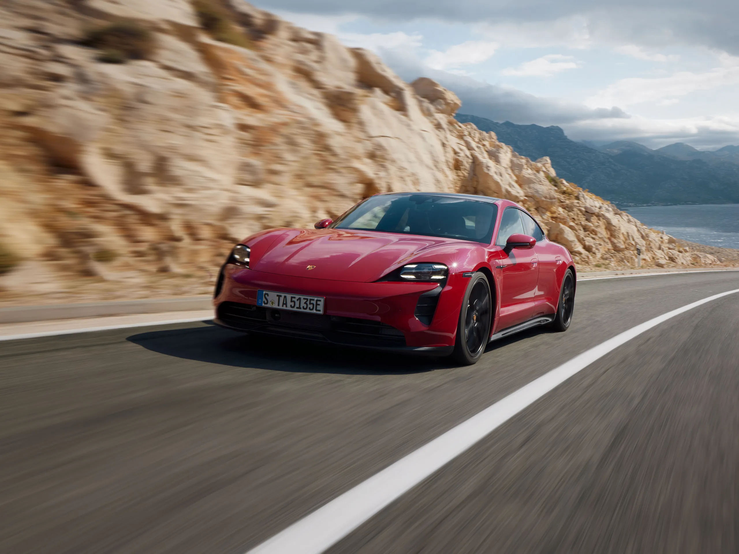 A Taycan GTS driving along a road.