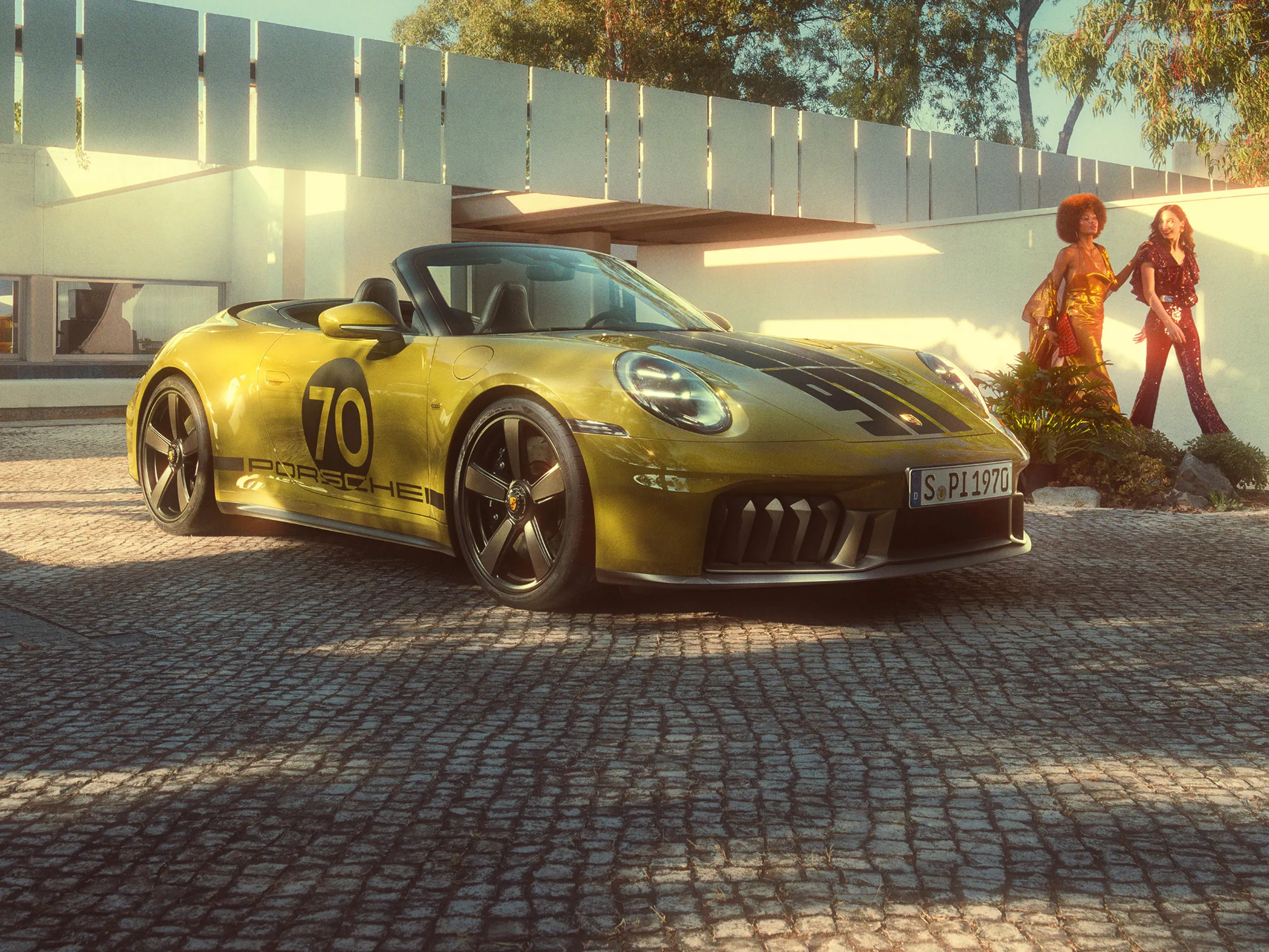Front and side views of a Porsche 911 Spirit 70 in an Olive Neo paint finish parked in a paved square.