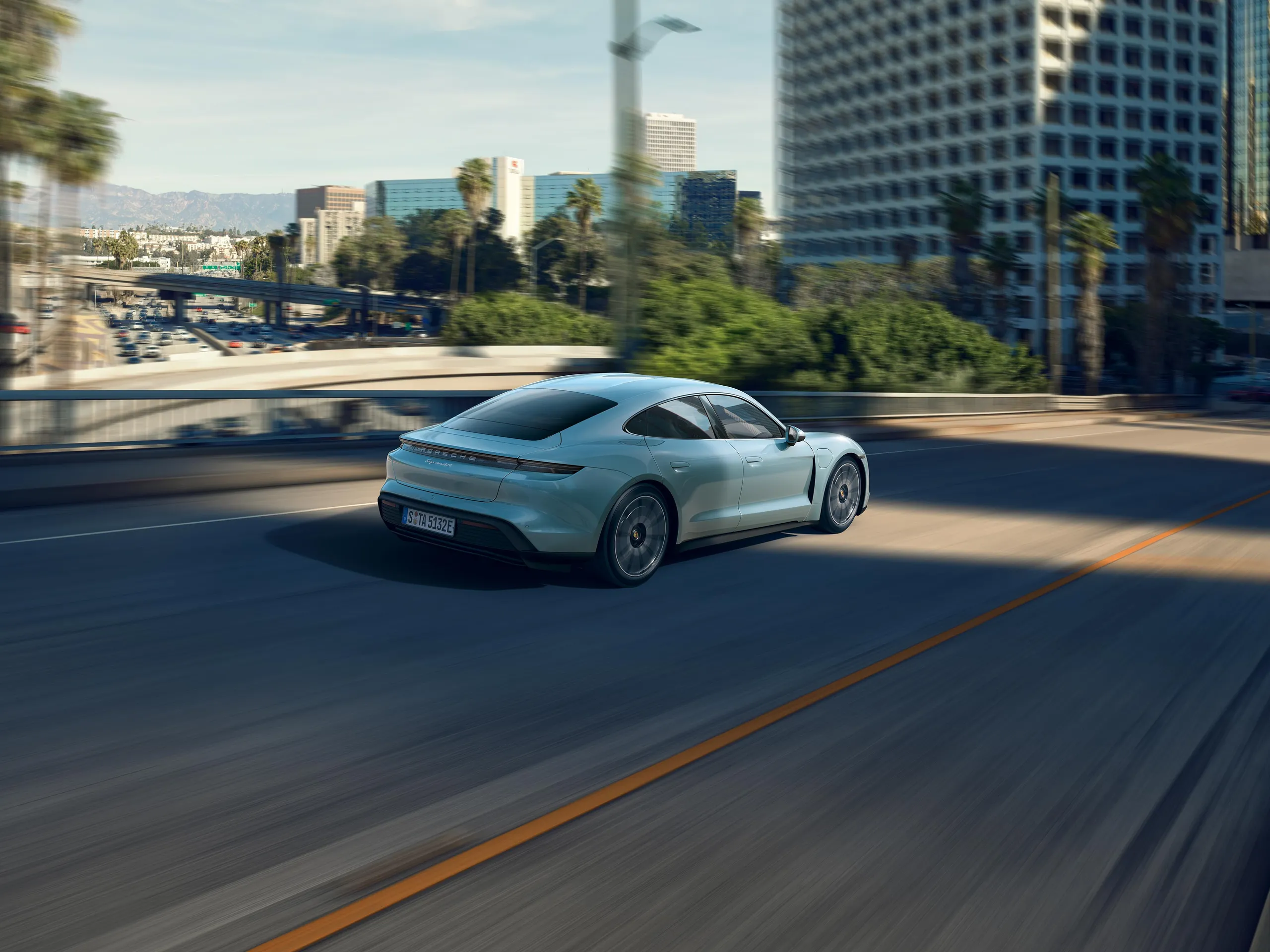 A Taycan 4S driving along a road.