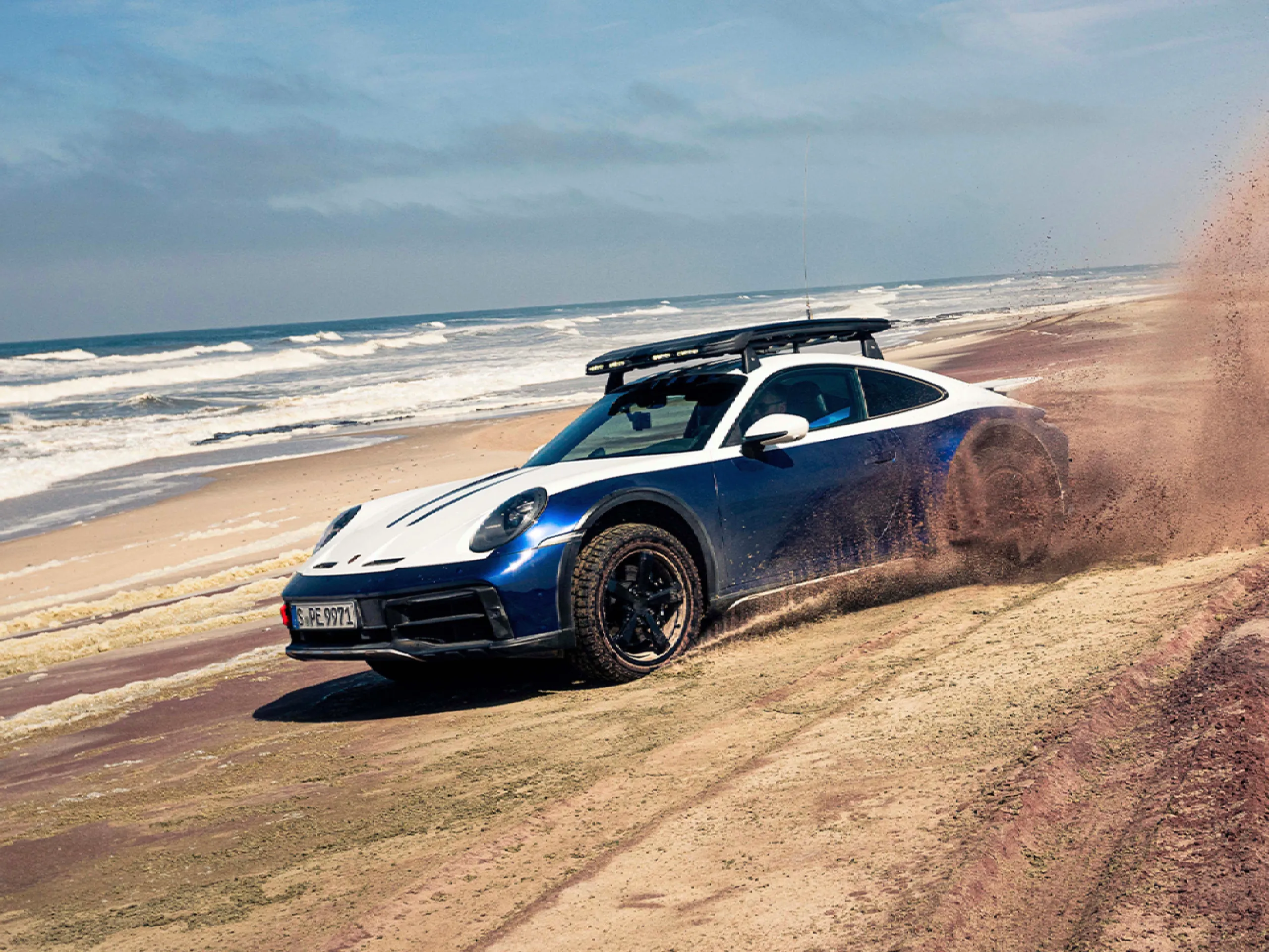 Porsche 911 Dakar driving on beach on Porsche Travel Experience Camp 911 Namibia