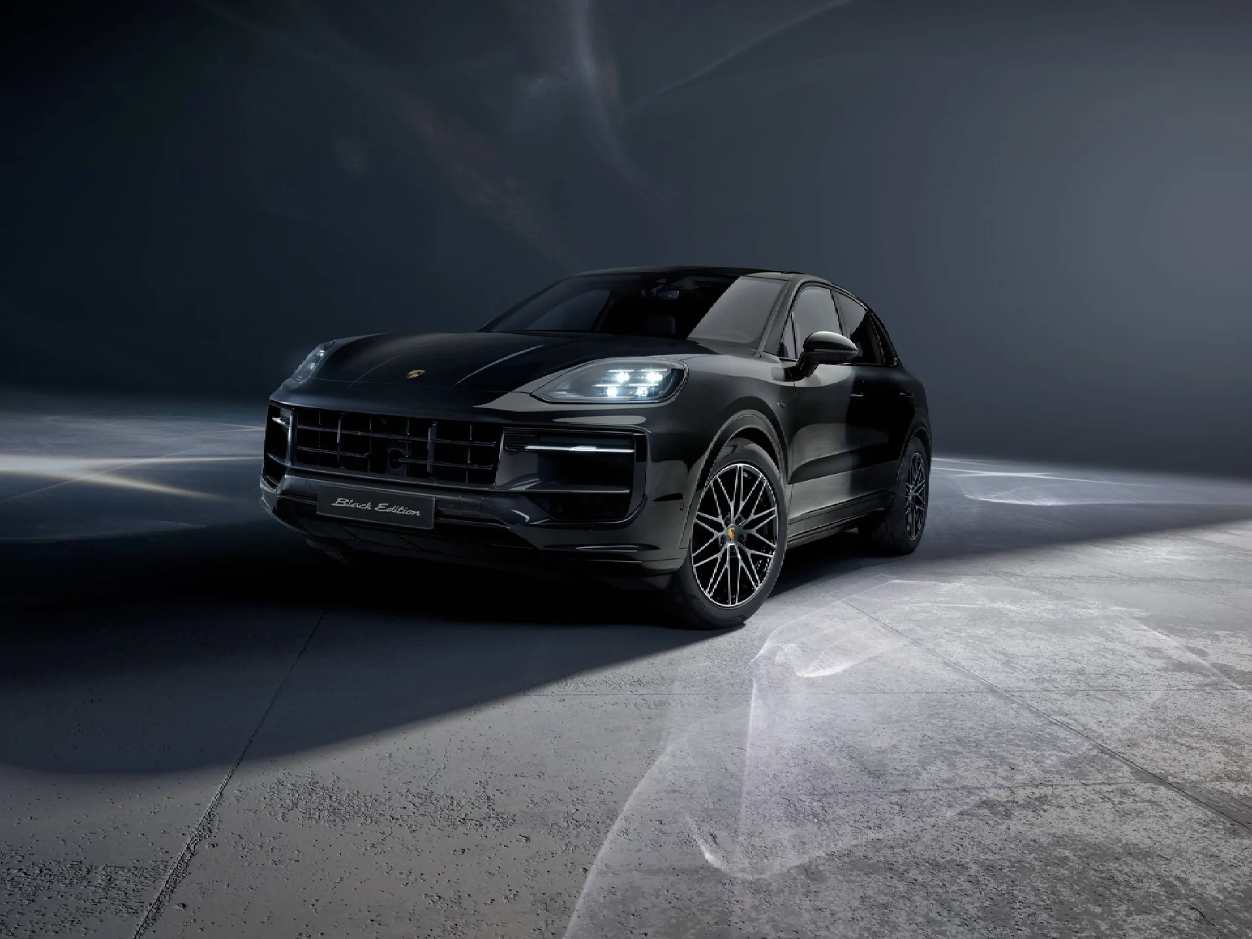 Shot of the front of a Cayenne E-Hybrid Black Edition in a dark location