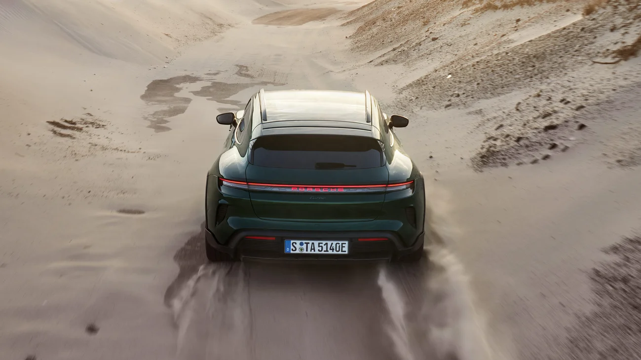 Several dynamic shots of an oakgreenmetallic neo colored Taycan Turbo Cross Turismo driving through the desert.
