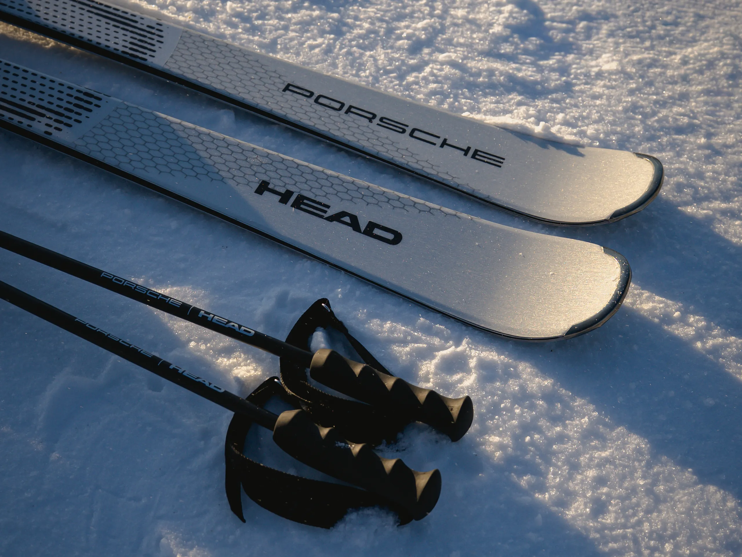 White Porsche x Head skis and ski pieces in the snow in the evening sun
