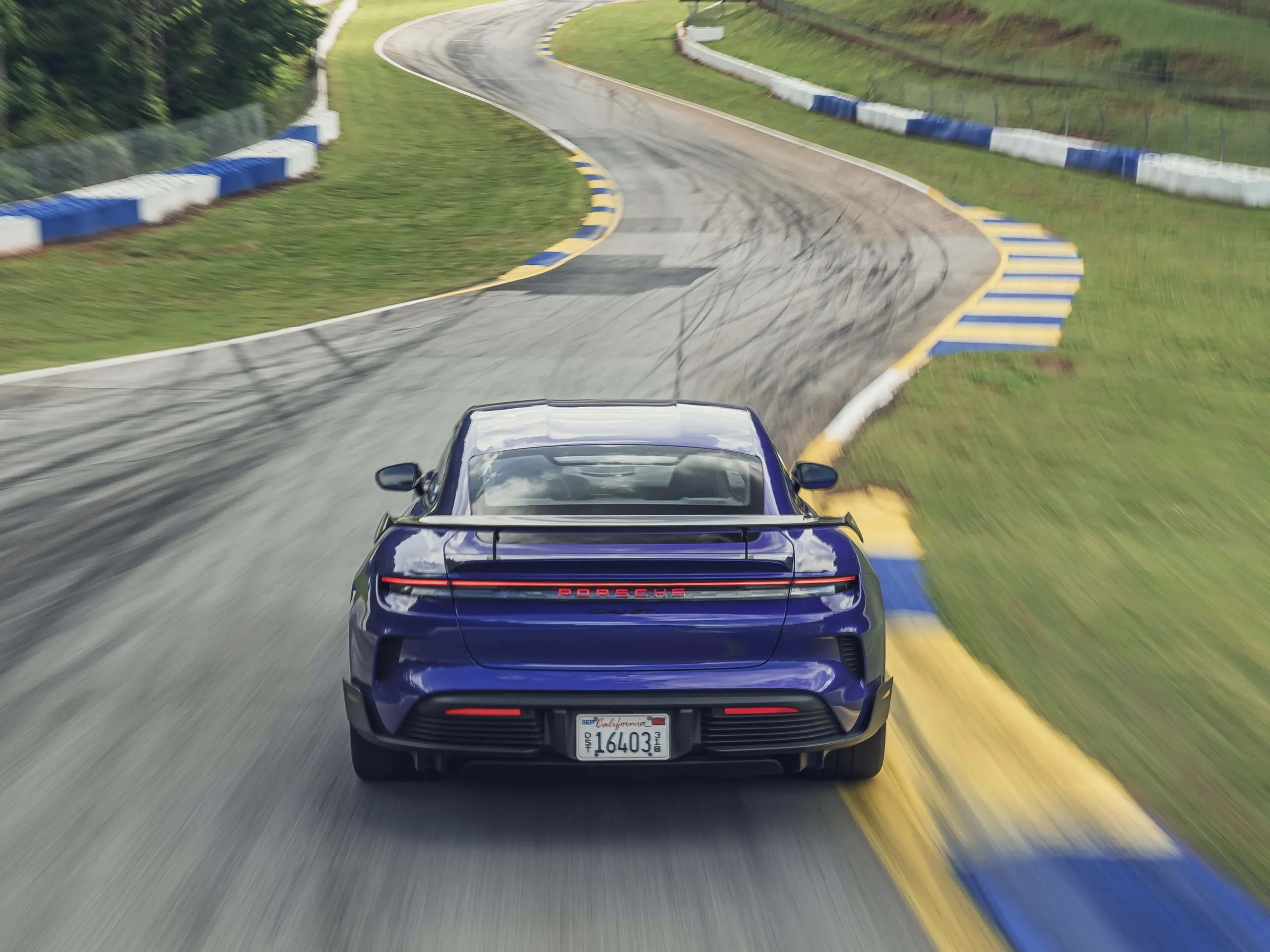 V2 Rear view of Porsche Taycan Turbo GT with Weissach package in Purple Sky Metallic at Road Atlanta race circuit
