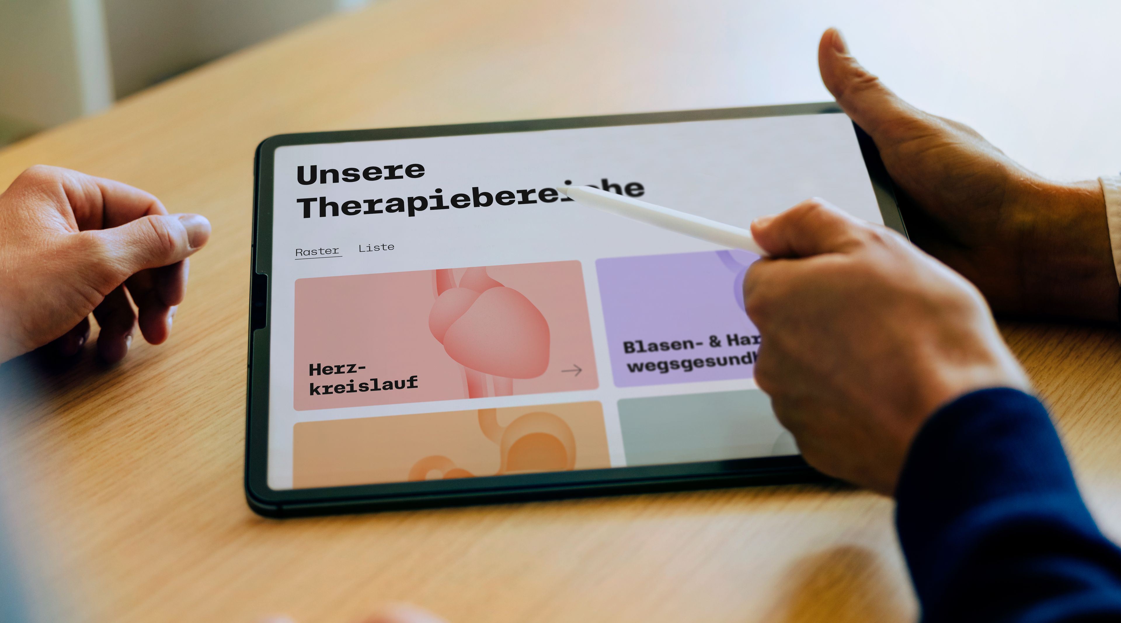 A hand points with a pen at a tablet displaying the homepage of AAA Pharma's new website.