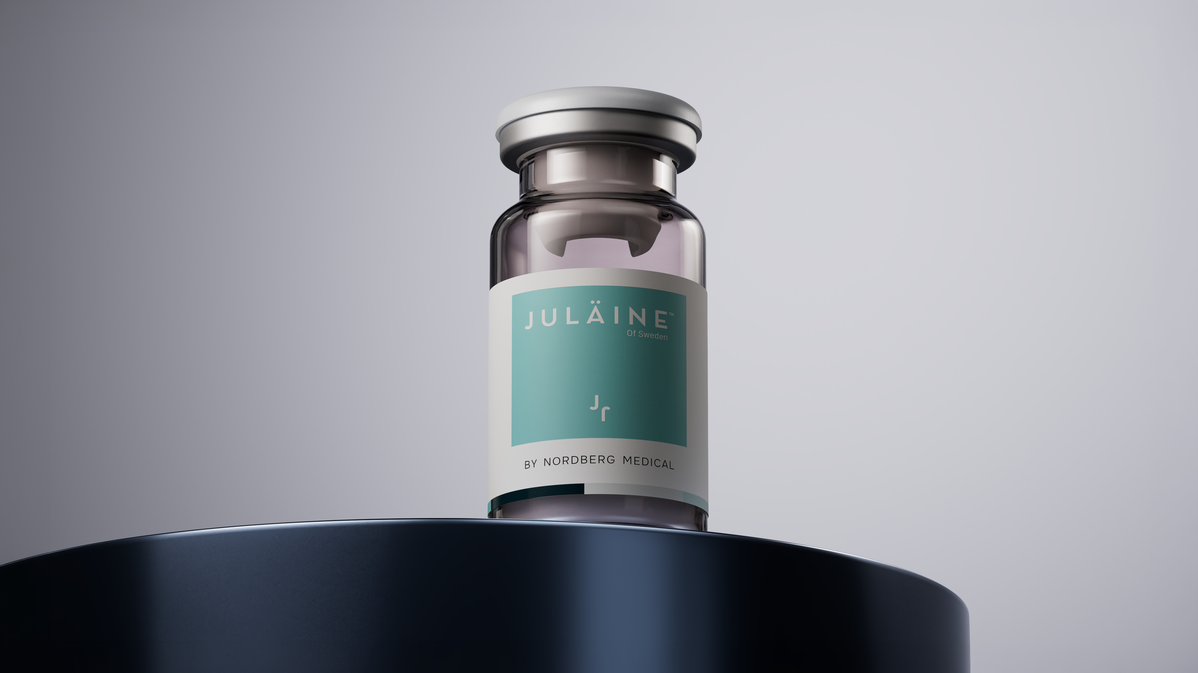 A JULÄINE of Sweden by Nordberg Medical glass vial placed on a dark circular platform against a light grey background.