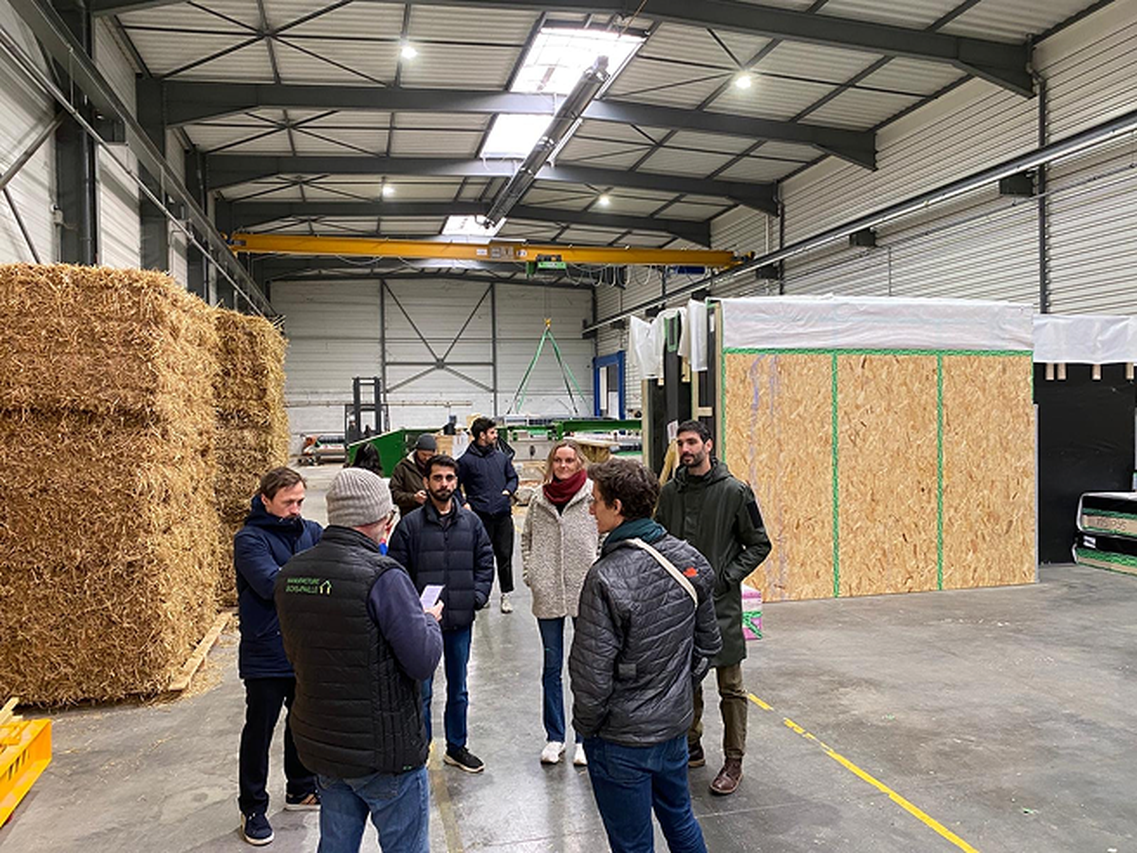 Rainbow team stand and converse in a large warehouse