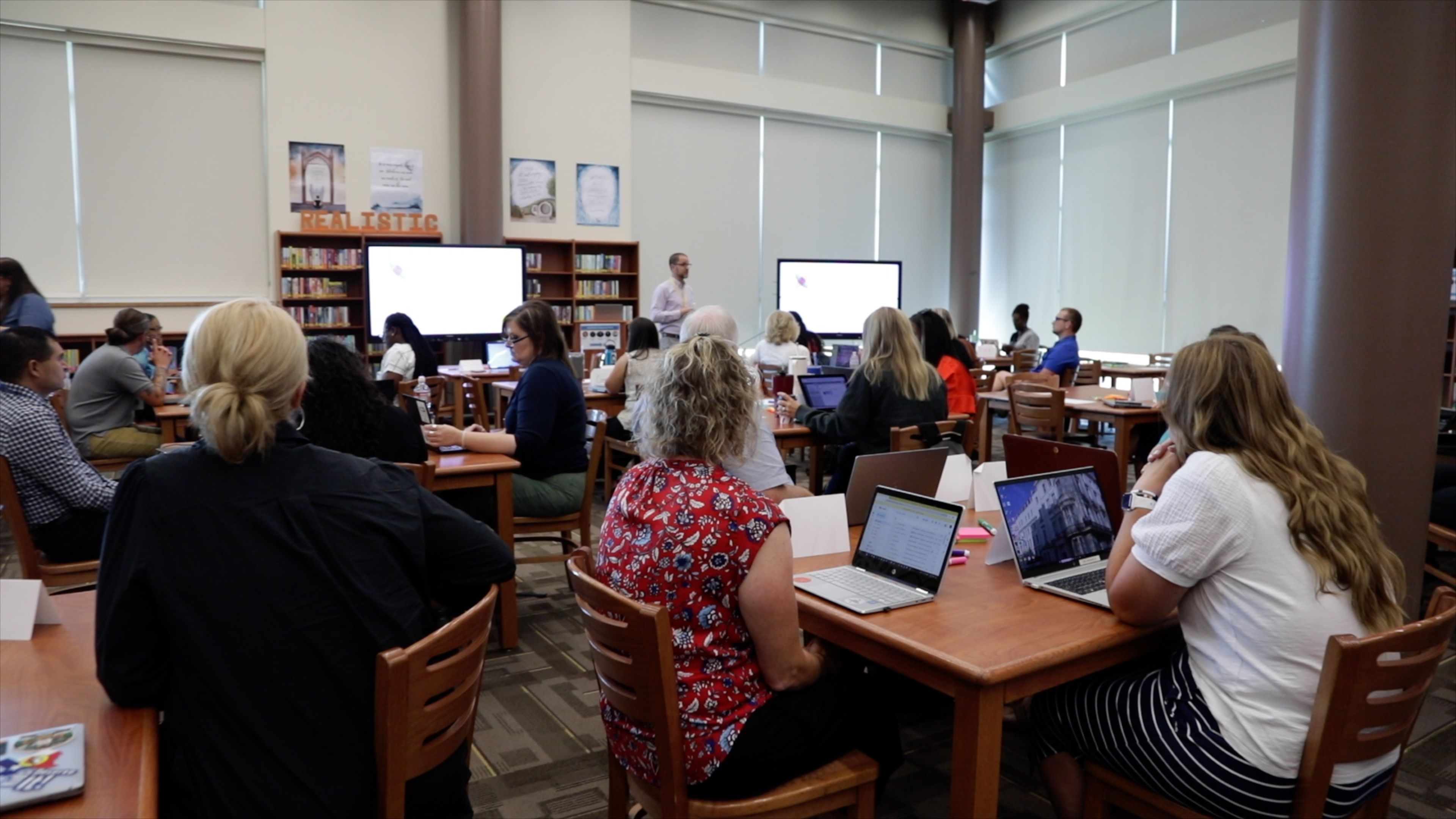 teachers-sitting-at-tables-with-their-laptops-open-during-a-training-in-Fort-Worth-Texas