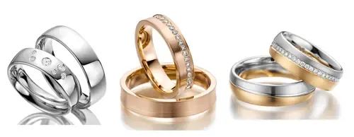 Drei Paar Eheringe: Silber mit Diamanten, Roségold mit Diamanten und eine Mischung aus Gold und Silber mit Diamanten.
