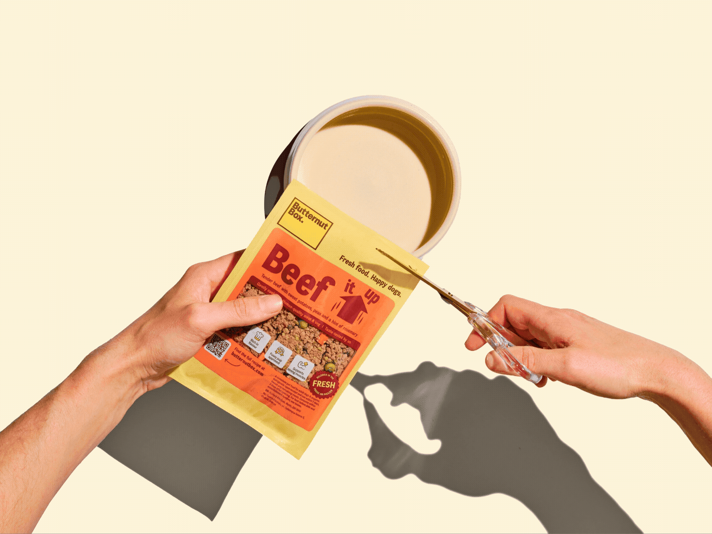 Animated image of a Butternut pouch of food being snipped open and emptied into a bowl