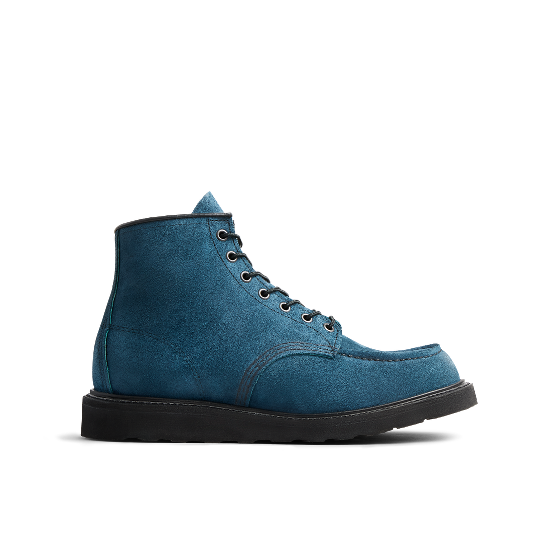 A blue suede ankle boot with black laces and a black sole, viewed from the side against a white background.