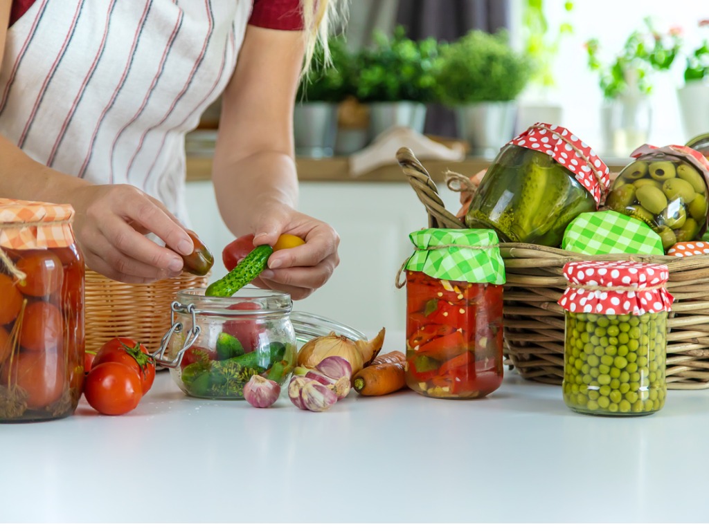 Woman with jars of fermented foods