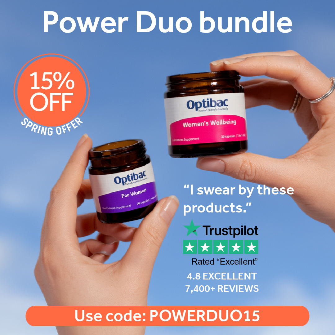 Two hands holding Optibac supplements against a blue sky, with promo text for a 15% off spring offer using code POWERDUO15.