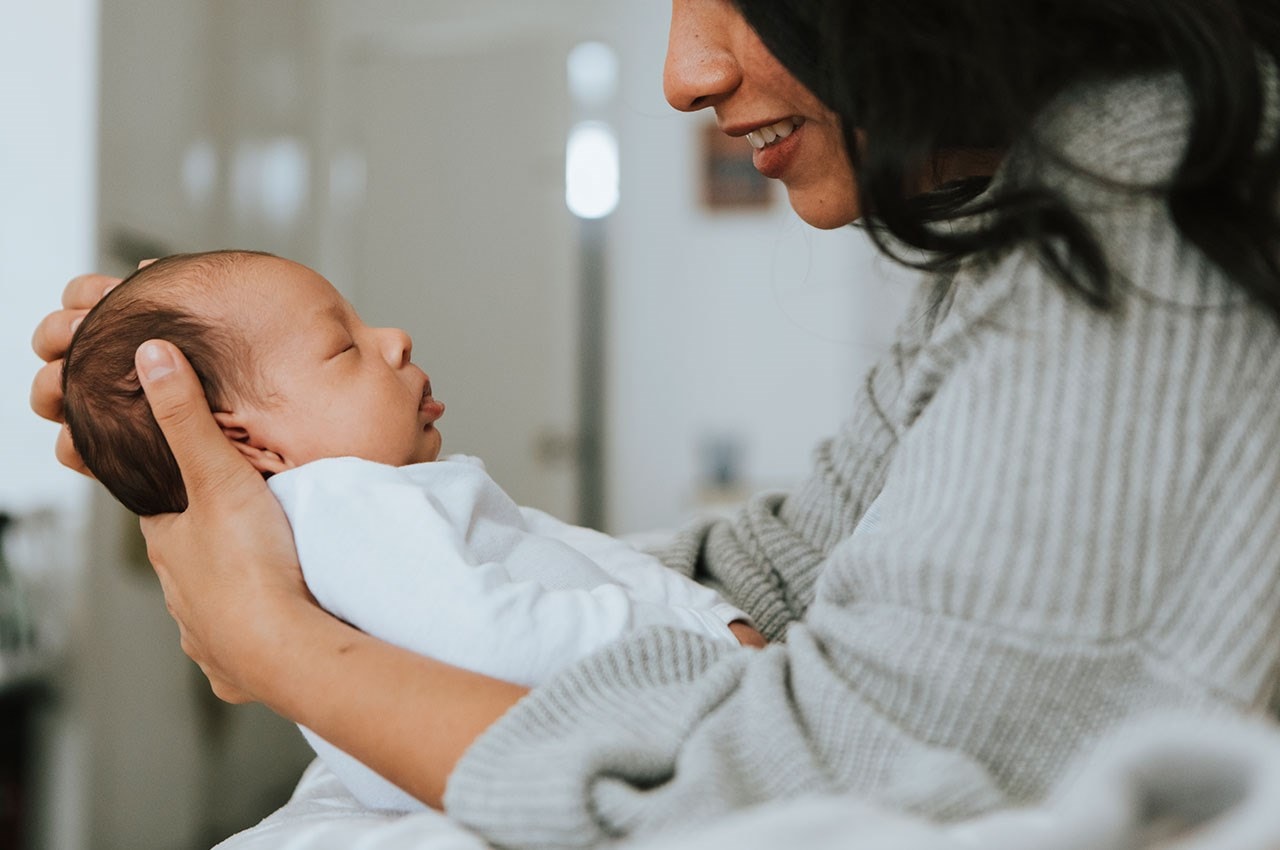 Mother cradling baby
