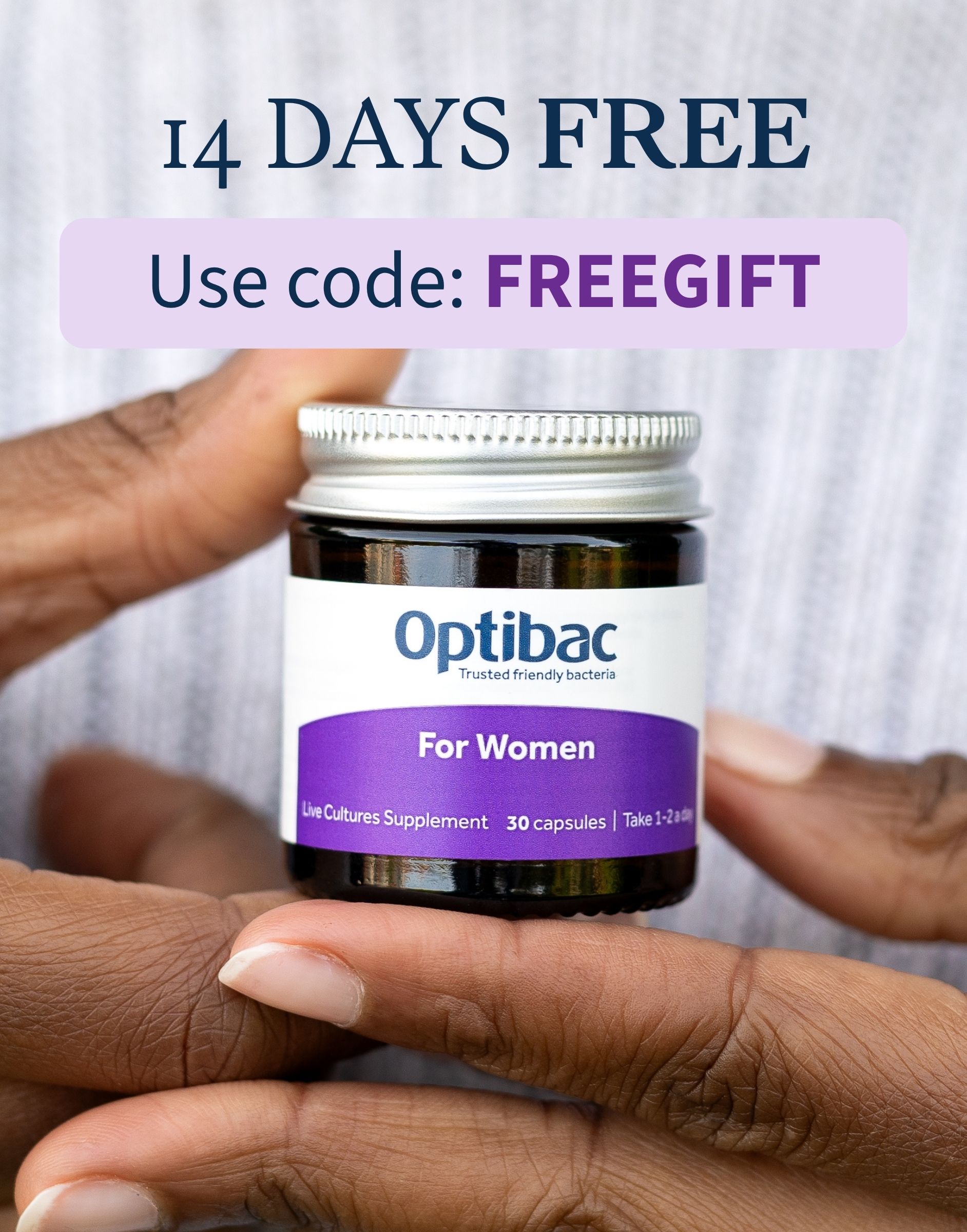 Close-up of a person holding a bottle of Optibac For Women supplement, with text offering 14 days free using code "FREEGIFT."