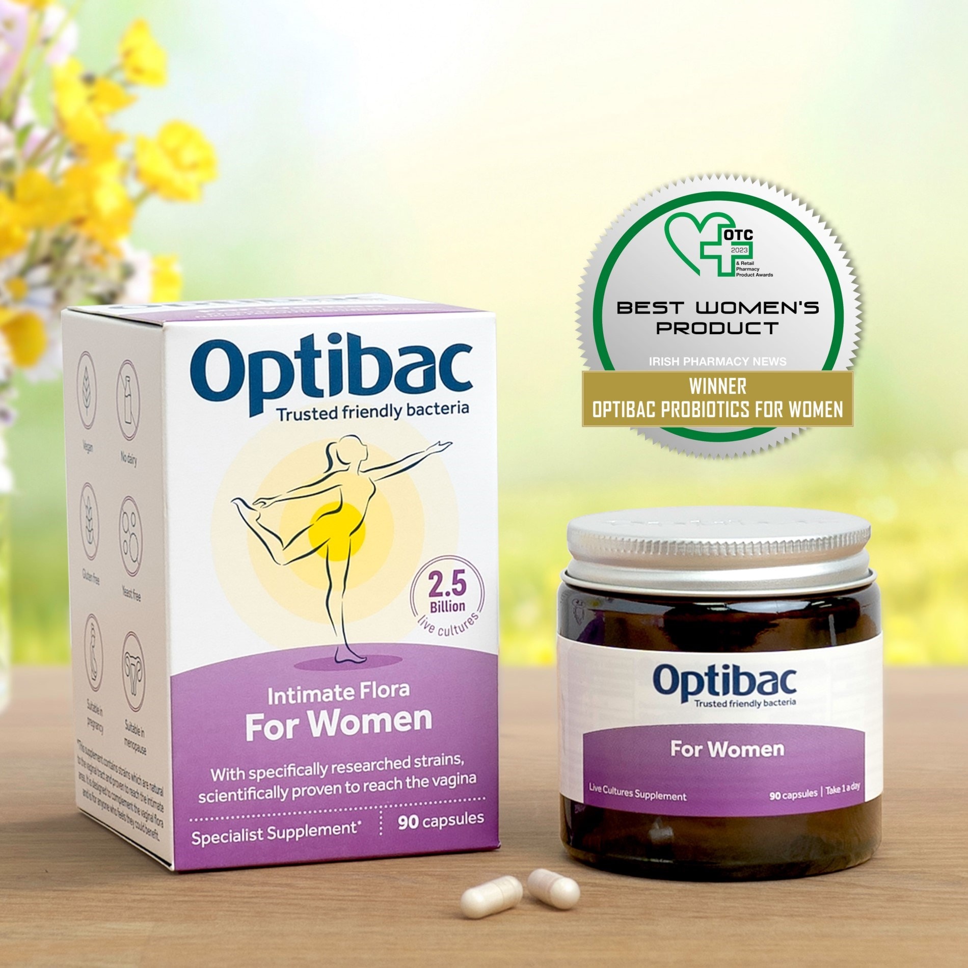 Optibac probiotics for women, featuring a box and jar on a wooden surface with a nature background and award badge.