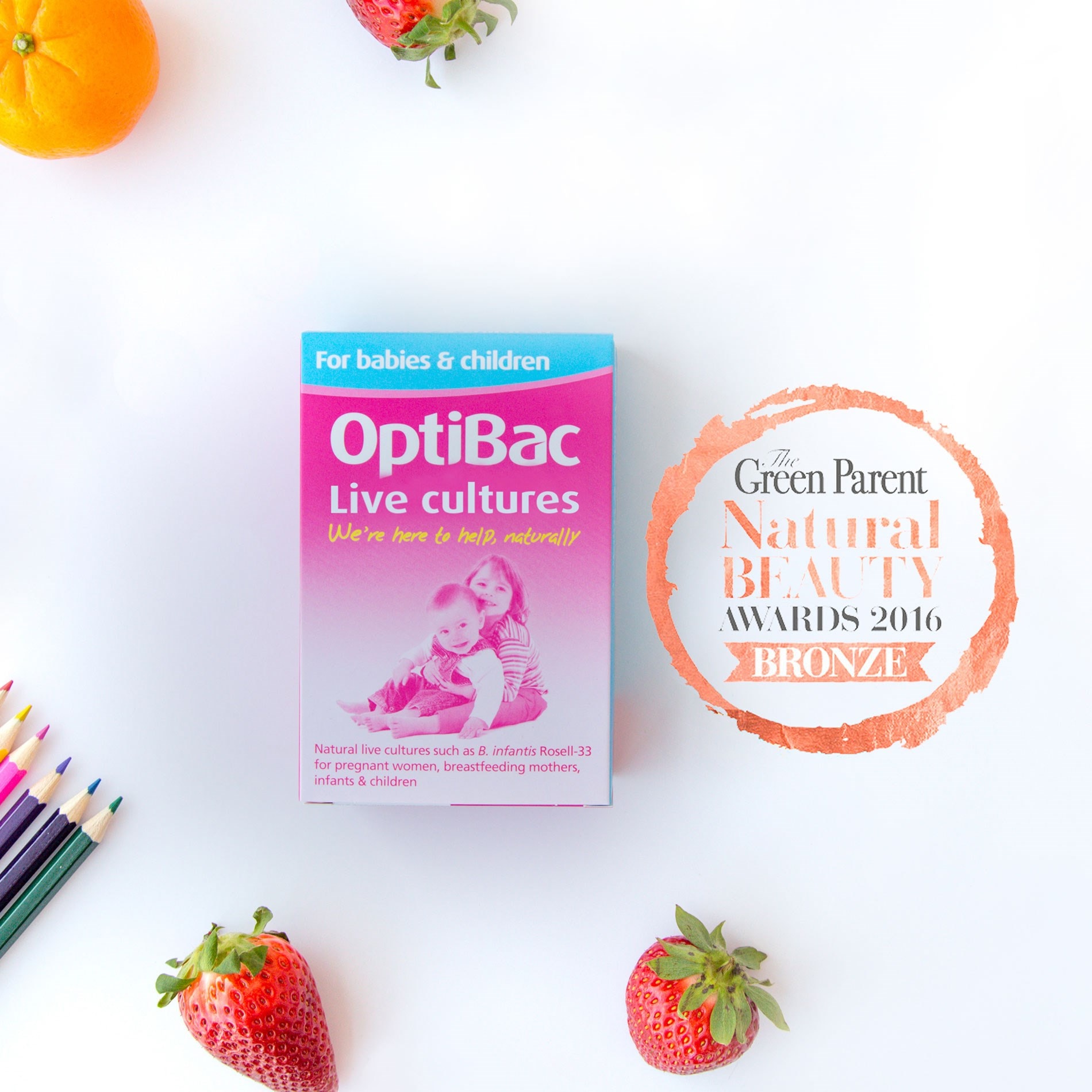 OptiBac Live Cultures box with fruits and colored pencils, featuring a 2016 Bronze Natural Beauty Award badge.