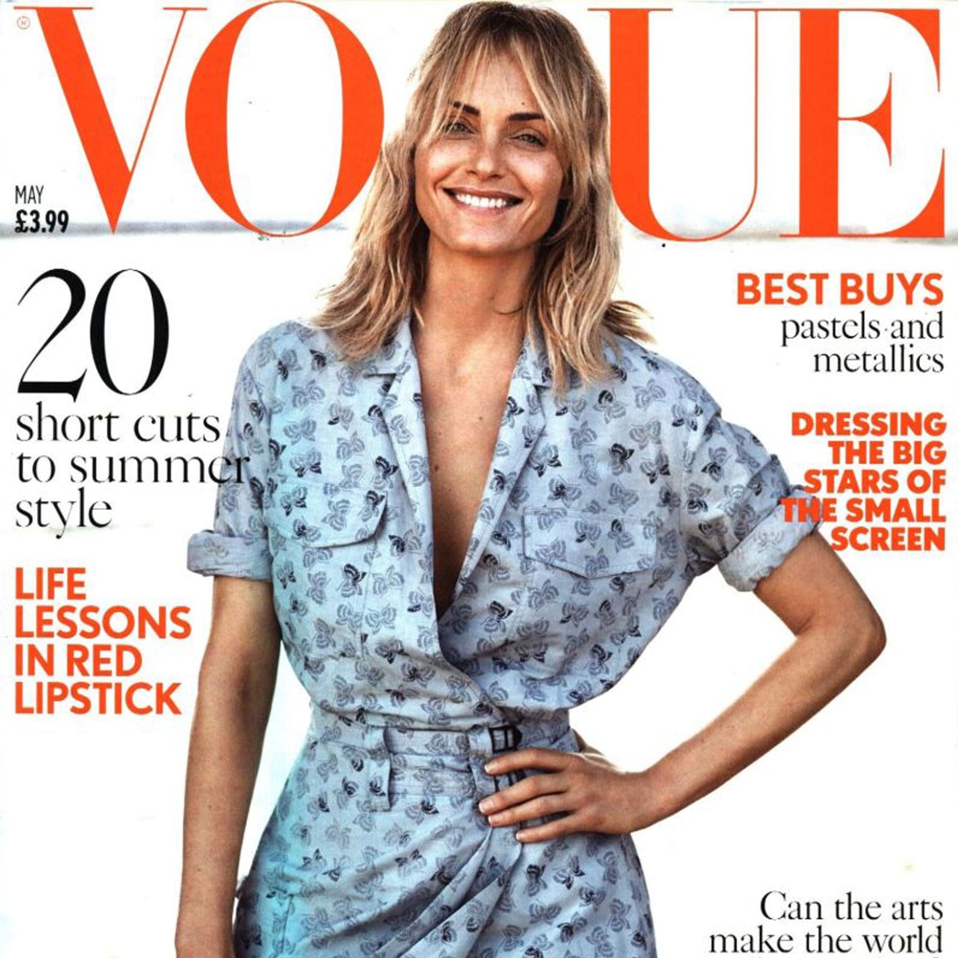 Smiling woman in a patterned blue dress on the cover of Vogue magazine, surrounded by text about fashion and lifestyle.