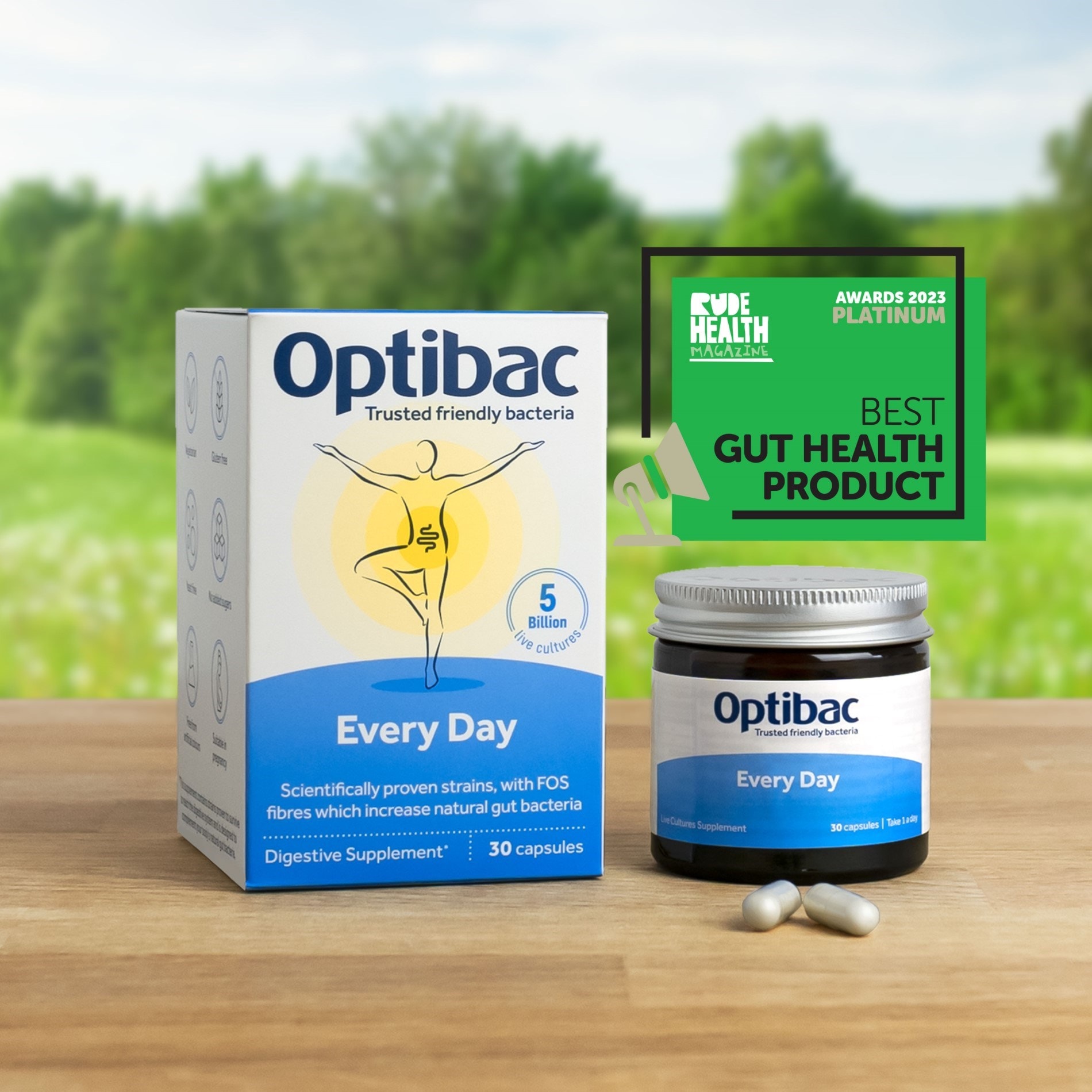 Optibac Every Day probiotic box and jar on a wooden table, with a "Best Gut Health Product" award in the background.