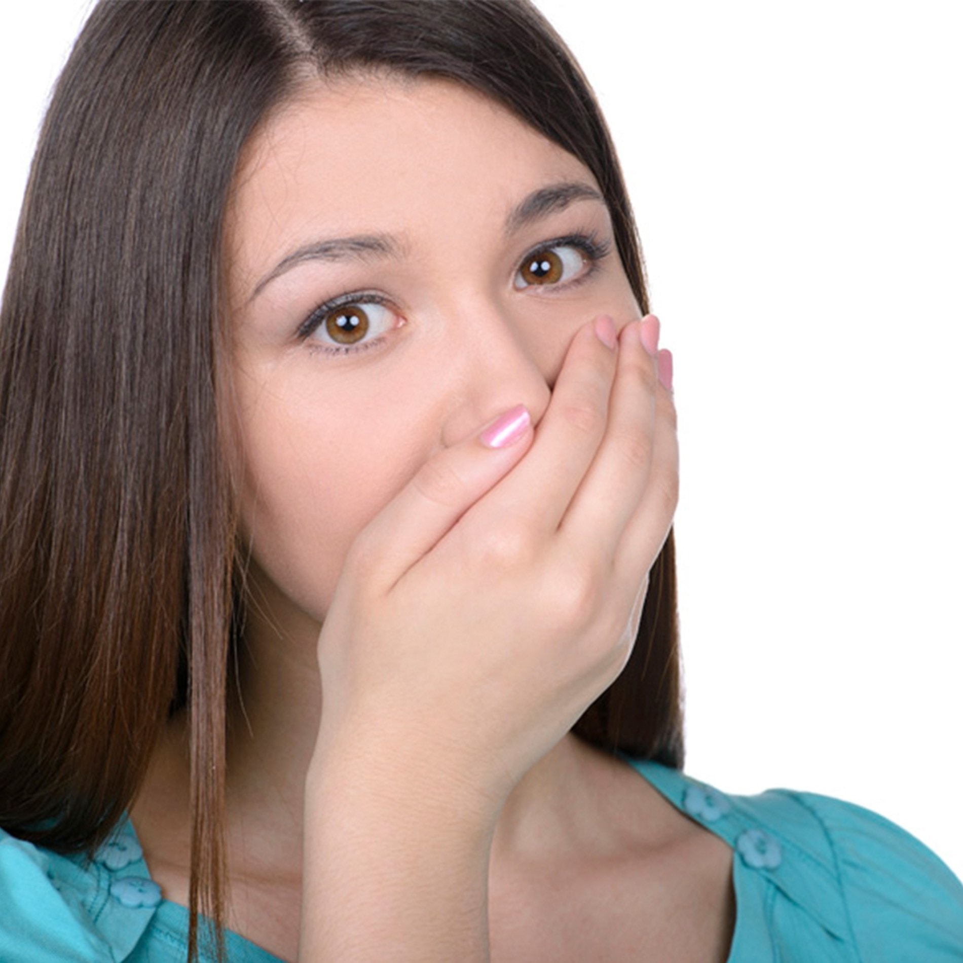 Woman with long brown hair covering her mouth with one hand, wearing a teal top, looking surprised against a white background.