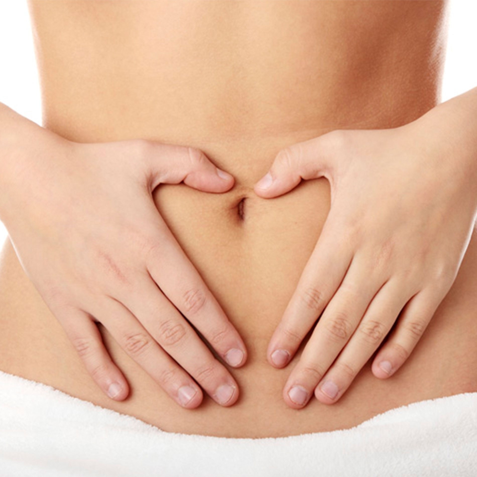 Hands forming a heart shape on a person's bare midriff, with a white towel wrapped around the waist.