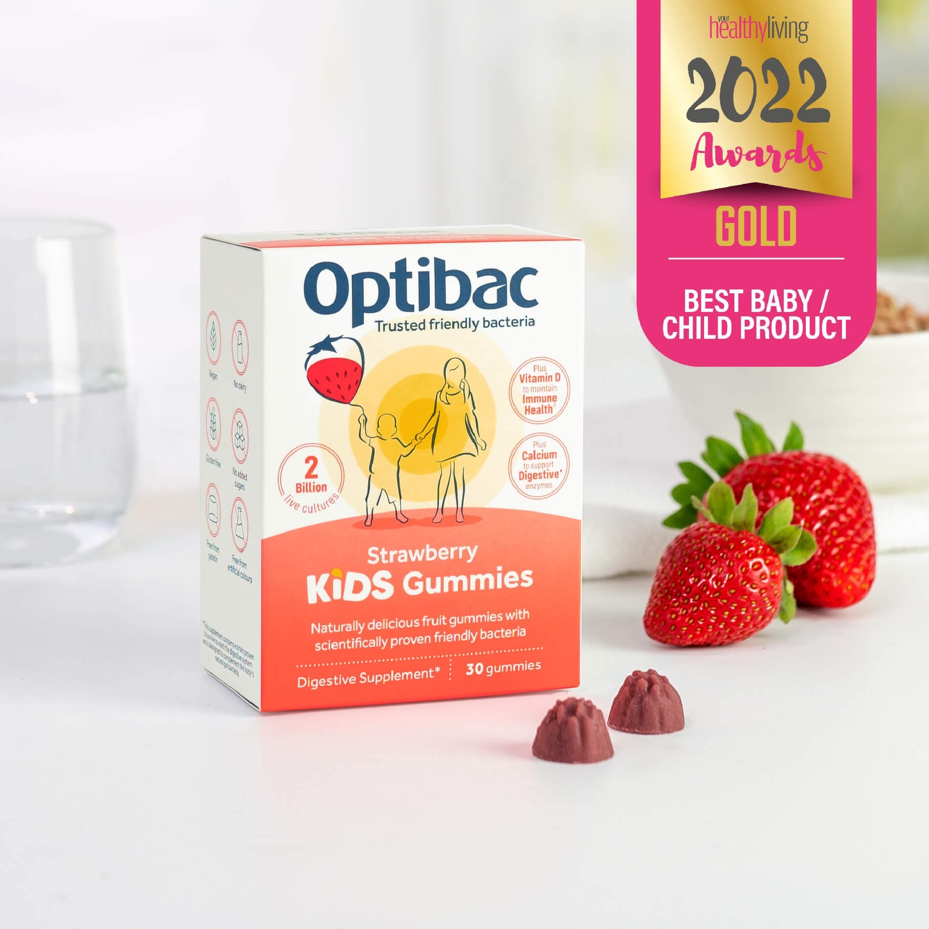 Box of Optibac Strawberry Kids Gummies on a table with strawberries and a glass, awarded "Best Baby/Child Product 2022."