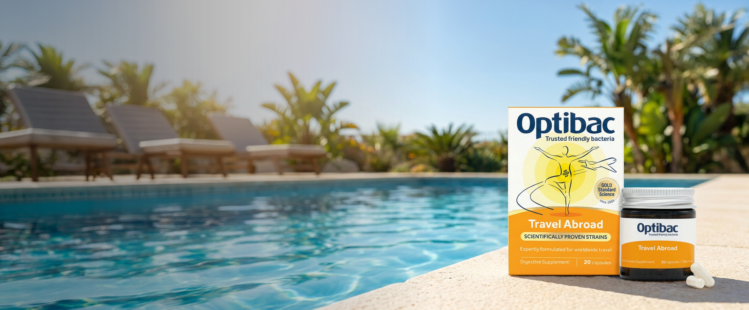 Optibac Travel Abroad probiotics on poolside, surrounded by tropical plants and lounge chairs under clear blue sky.