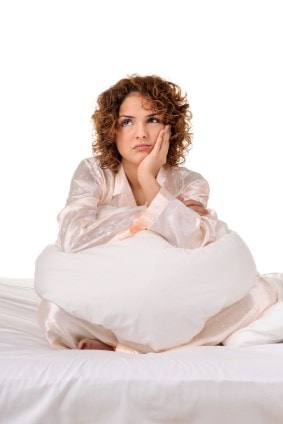 Woman sitting on a bed