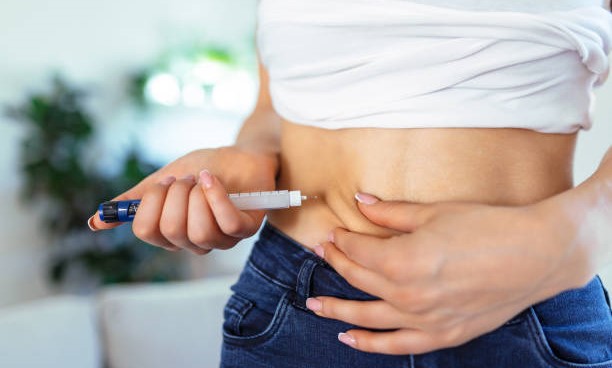 Woman with diabetes injecting herself