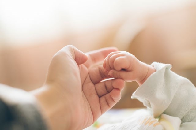 Mother holding a baby's hand
