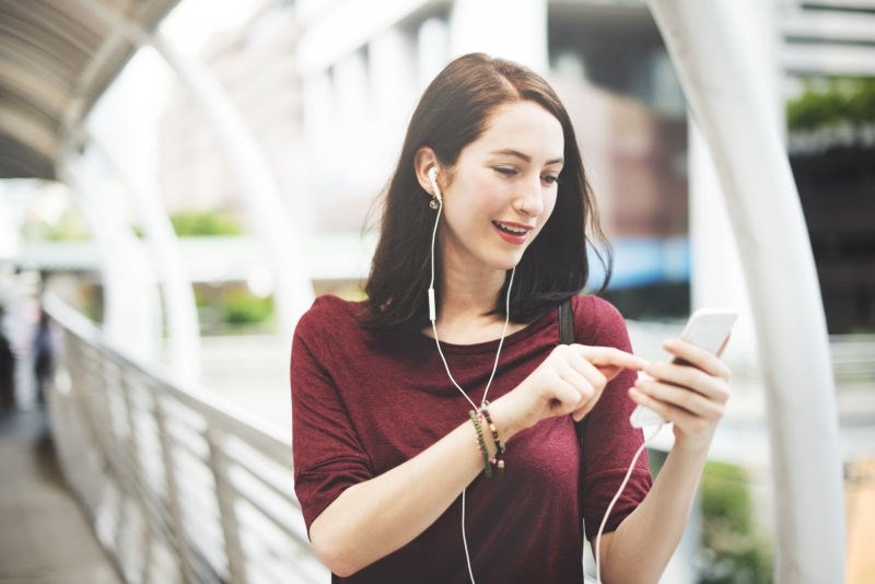 emale listening to earphones from phone